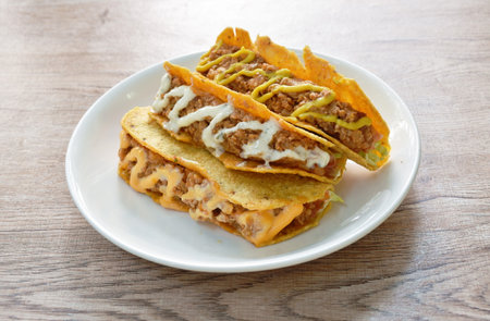 taco Mexican food stuffed fried chop pork with sauce  dressing mayonnaise and mustard sauce on plate