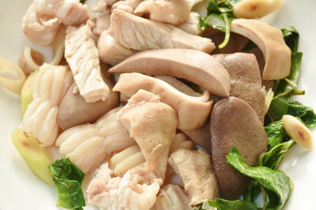 boiled slice pork meat and organ on plate dipping spicy and sour chili sauceの写真素材