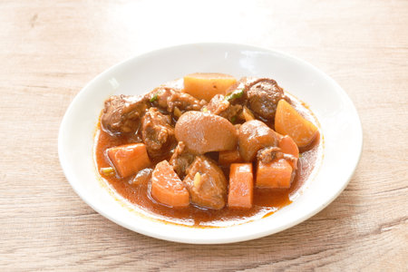 boiled pork leg with carrot in sweet red gravy sauce stew on plateの写真素材