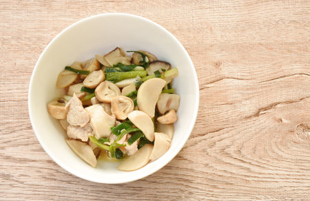 stir fried mixed mushroom with pork in oyster sauce on plateの写真素材