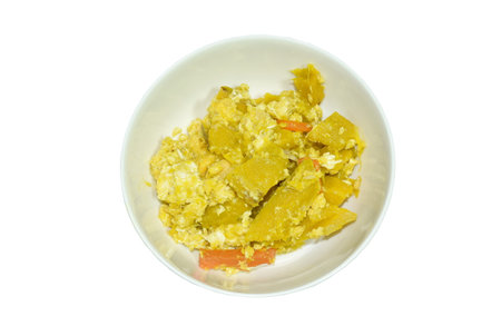 stir fried pumpkin with egg on plate in white backgroundの写真素材