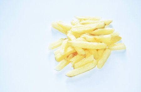 crispy snack French fries mixed with salt arranging on white backgroundの写真素材
