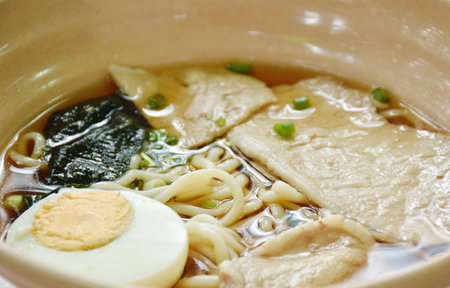 shoyu ramen or Japanese yellow noodles topping slice braised pork and boiled egg  in soy sauce soup on bowlの写真素材
