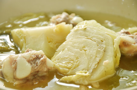 boiled pickled cabbage with pork bone in clear soup on plateの写真素材