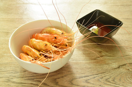 baking sat river shrimp arranging on bowl dipping spicy sauceの写真素材