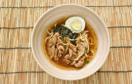shoyu ramen or Japanese yellow noodles topping slice braised pork and boiled egg  in spicy soy sauce...