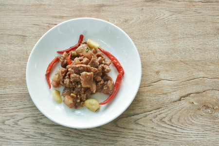 spicy stir fried pork belly with chili in shrimp paste sauce on plateの写真素材