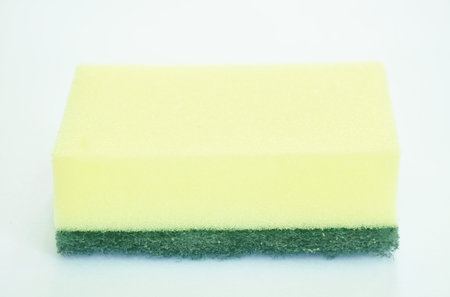 yellow and green scrub sponge with liquid washing on white backgroundの写真素材