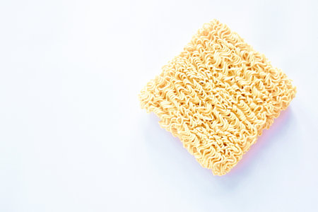 raw dry instant noodles on white backgroundの写真素材