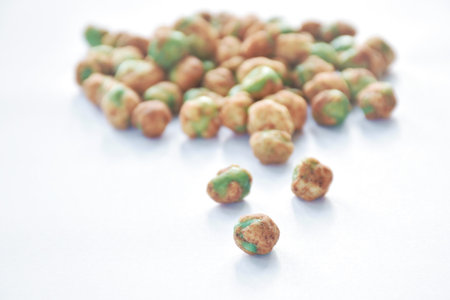 baked salt green pea with seasoning arranging on white backgroundの写真素材