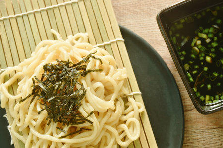 Zaru soba cold Japanese noodles topping chop seaweed dipping shoyu sauce with slice spring onion on...