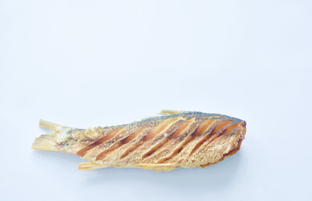 deep fried salty mullet fish arranging on white backgroundの写真素材