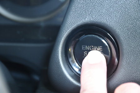 car engine start by finger pushing button in cockpitの写真素材