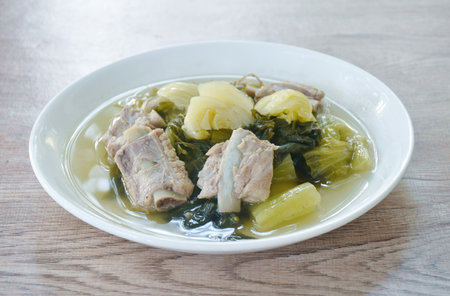 boiled pickled cabbage with pork bone in clear soup on plateの写真素材
