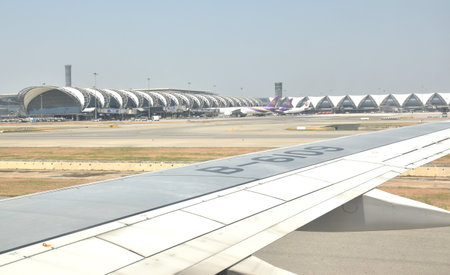 Samutprakan Thailand March 7, 2024 : wing on commercial plane landing on Suvarnabhumi airportのeditorial素材