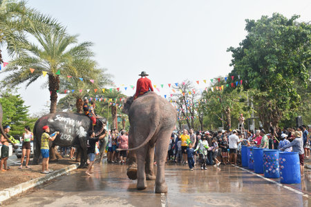 Ayutthaya Thailand April 14, 2024 : elephant splashing water between tourist in Songkarn festivalのeditorial素材