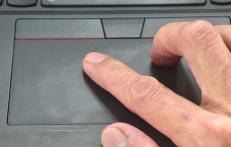 human hand used touchpad of computer laptop for working
