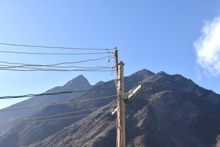 electric pole on mountain background at Diexi lake with green water surface at Chengdu travel location in Chinaの写真素材