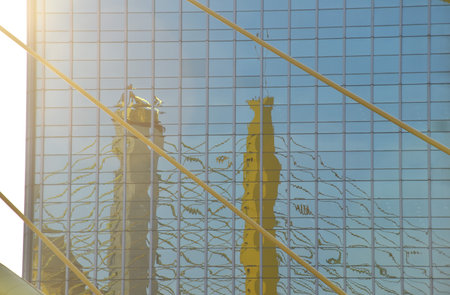 reflection of Thotsamarachan Bridge suspension bridge cross Chao Phraya river on glas building in...