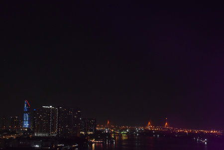 bridge and building cityscape on river in night at Thailandの写真素材