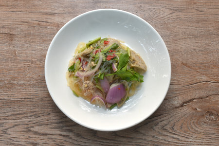 glass noodles with Vietnamese sausage and chop pork spicy salad on plateの写真素材