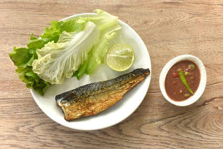 grilled saba mackerel fish and spicy shrimp chili paste sauce on plate eat couple with fresh vegetableの写真素材