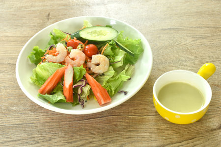 boiled shrimp and crab stick with vegetable seafood salad on plate dressing cream sauceの写真素材
