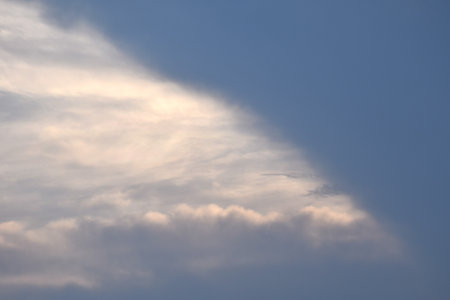 white and dark rain cloud floating on sky in eveningの写真素材