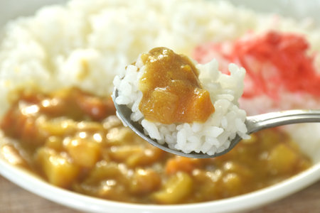 pork with potato and carrot in Japanese curry with rice topping slice red pickled cabbage on plateの写真素材