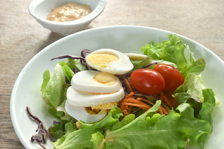 boiled egg with vegetable thousand island salad on plate dressing cream sauceの写真素材