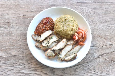 grilled slice chicken black pepper steak dressing tomato sauce with fried rice on plateの写真素材