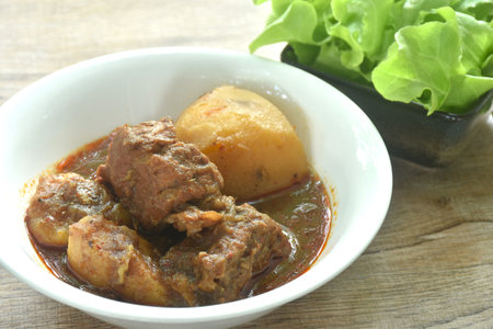 beef curry or Mussamun with slice potato on bowl eat with fresh lettuceの写真素材