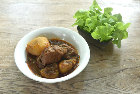 beef curry or Mussamun Indian food with slice potato on bowl eat with fresh lettuceの写真素材