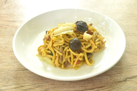 fried noodles and cabbage with mushroom on plateの写真素材