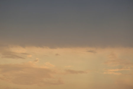 white and dark cloud floating on orange sky in eveningの写真素材