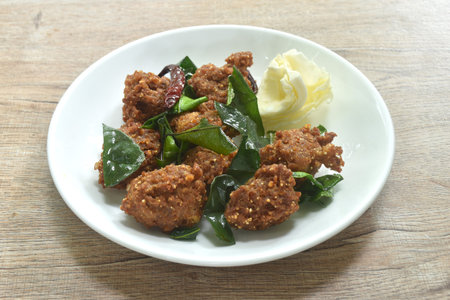 deep fried spicy chop pork ball Thai salad taste spicy and sour with cabbage on plateの写真素材