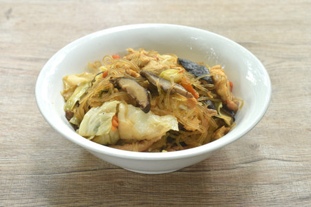fried glass noodles slice pork and cabbage with egg on bowlの写真素材