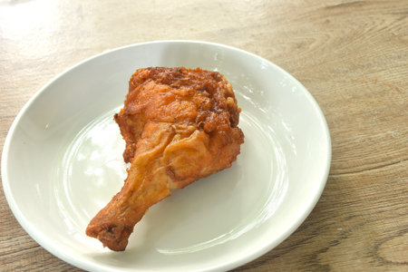 crispy fried chicken tight and leg with herb on plateの写真素材
