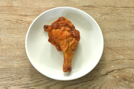 crispy fried chicken tight and leg with herb on plateの写真素材