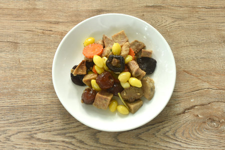 deep fried tofu and gluten with yellow ginkgo and pickled jujube couple black mushroom in soy sauce vegetarian food on plateの写真素材