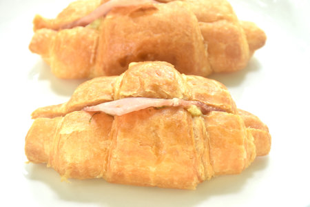baking crispy butter croissant French bread stuffed ham cheese and spinach on plateの写真素材