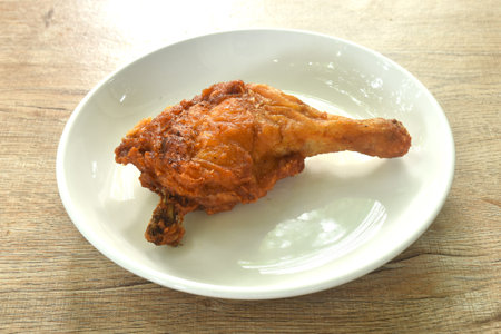 crispy fried chicken tight and leg with herb on plateの写真素材