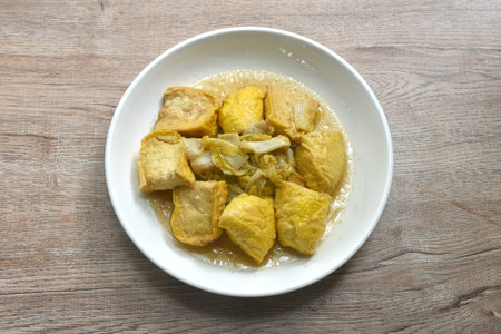 fried cabbage with slice soft yellow tofu vegetarian food on plateの写真素材