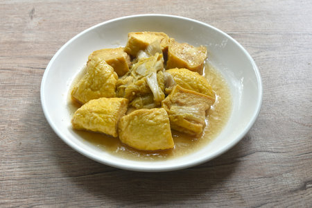 fried cabbage with slice soft yellow tofu vegetarian food on plateの写真素材