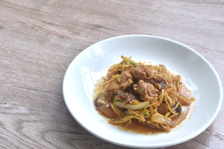stir fried chicken with slice ginger and black ear mushroom on plateの写真素材
