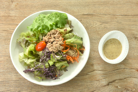 chop tuna with vegetable salad on plate dressing sesame oil japanese cream sauceの写真素材