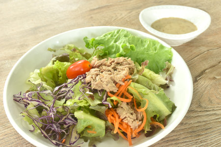 chop tuna with vegetable salad on plate dressing sesame oil japanese cream sauceの写真素材