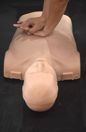 woman hand training CPR or cardiopulmonary resuscitation to helping life from heart diseaseの写真素材