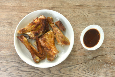 roasted chop chicken meat wing and leg on plate dipping with sweet and spicy sauceの写真素材