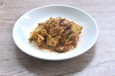 stir fried chicken with slice ginger and black ear mushroom on plateの写真素材